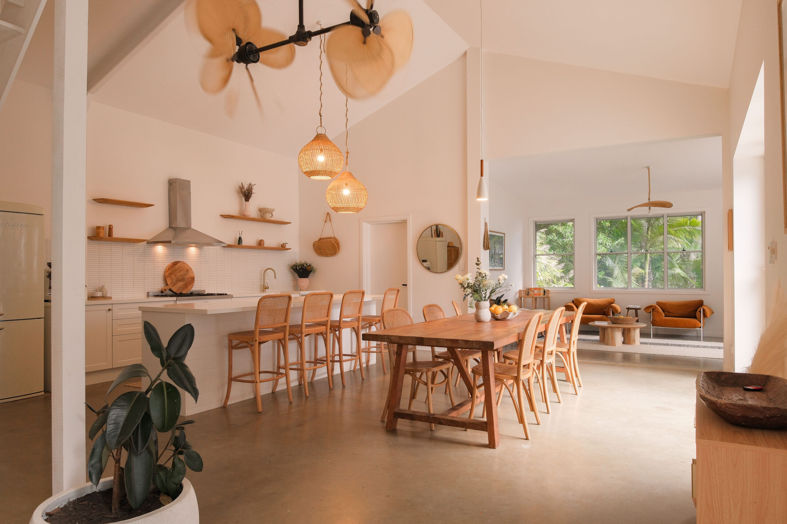 Open-plan kitchen and dining area at Bailen Byron in Ewingsdale, styled with earthy tones and natural textures.